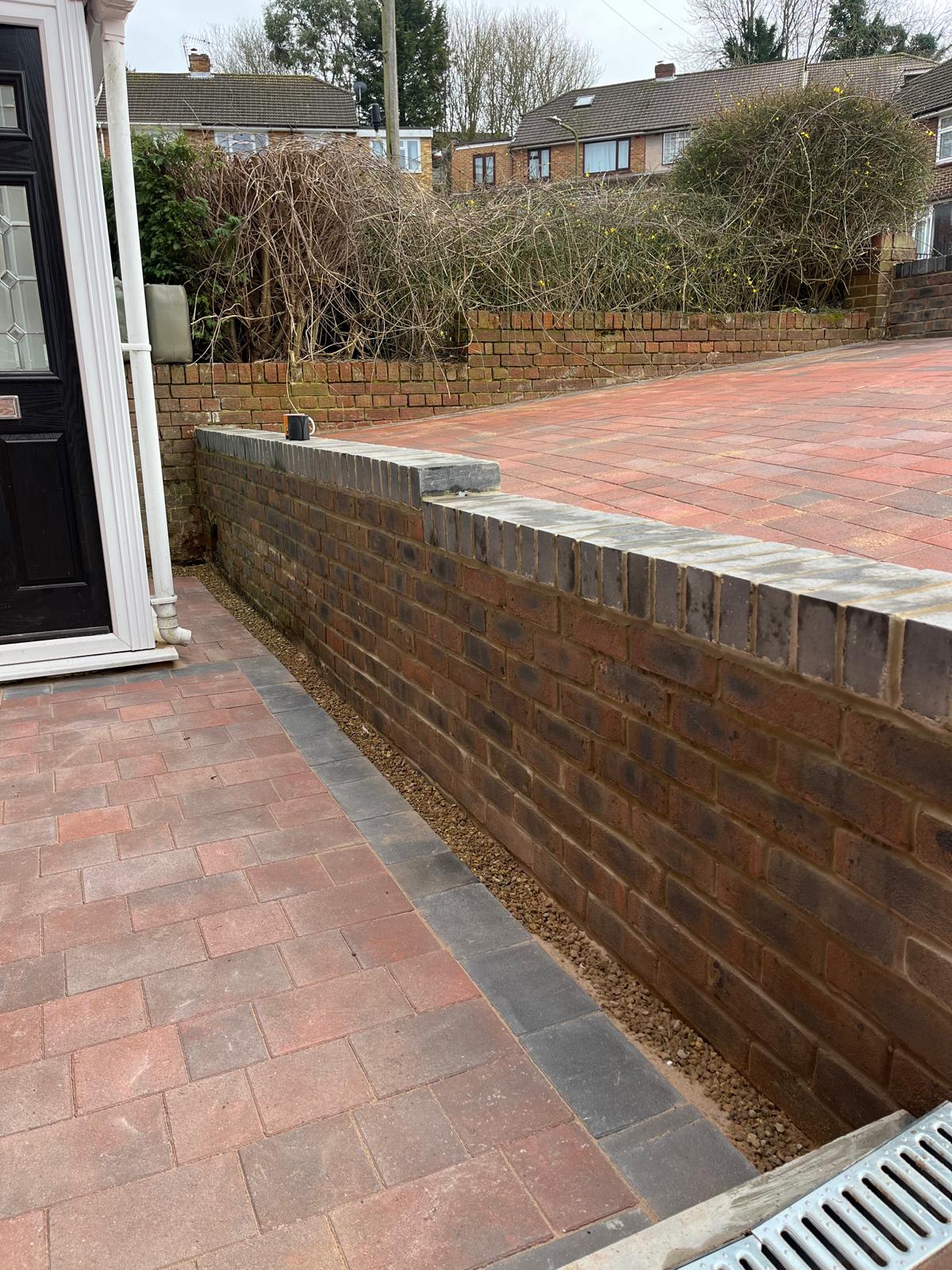 Brick retaining wall with block paving driveway in Medway