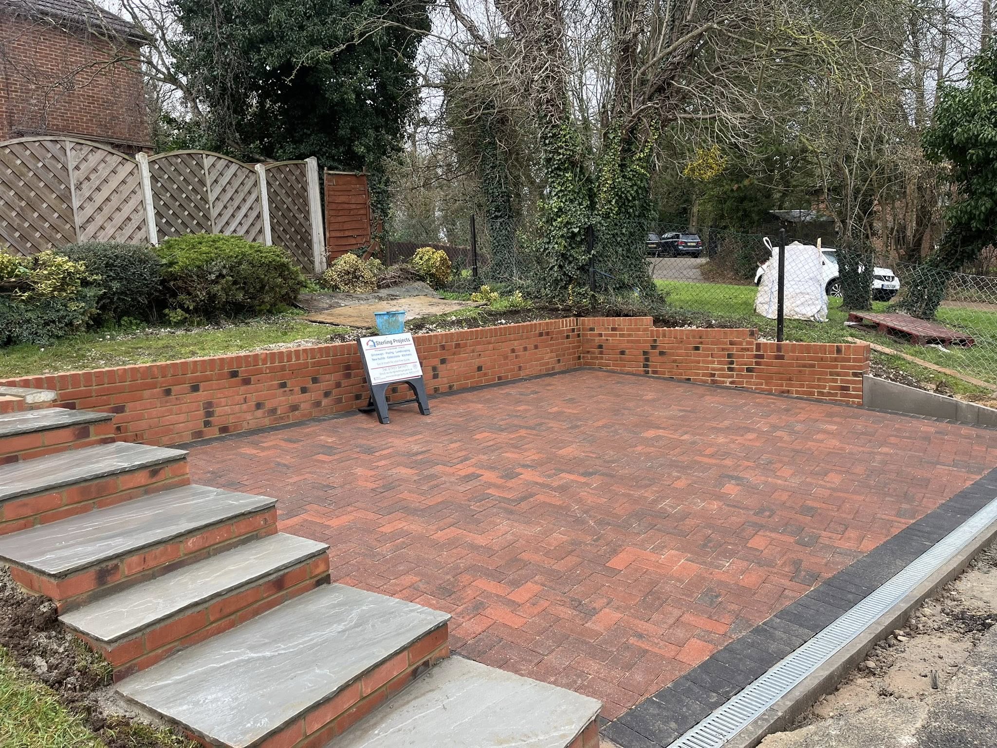 Red stock brick retaining walls with Brett omega block paving driveway and sandstone steps Maidstone